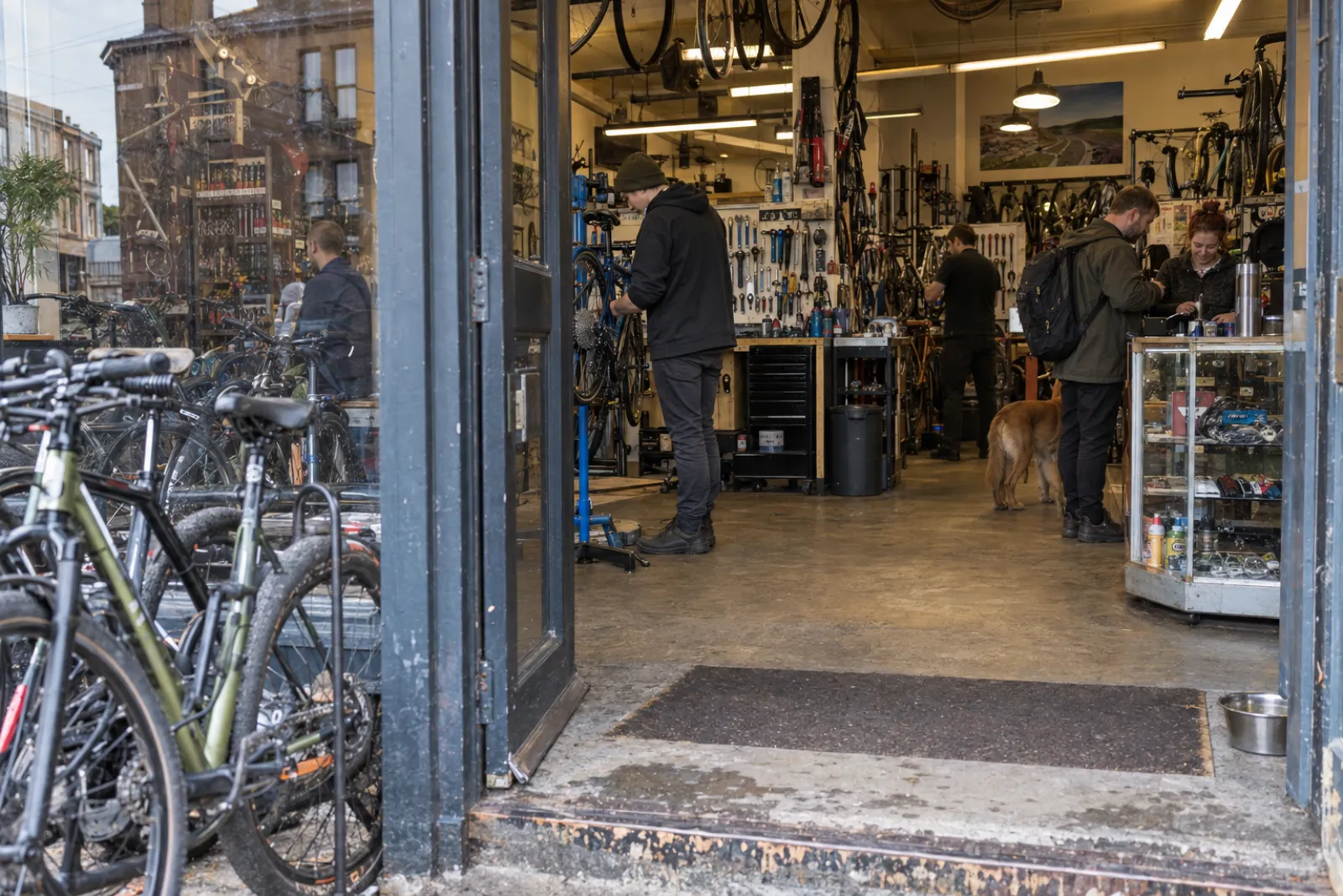 The shop front on Kilbowie Road, doors open, a bike on the stand just inside
